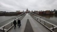 Pedestrians walk across The Millenium Bridge, amid the coronavirus disease (COVID-19) outbreak, in London, Britain, January 5, 2021. REUTERS/Henry Nicholls