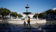 People walk by Rossio square on the first day of the second national lockdown due to coronavirus disease (COVID-19) pandemic in Lisbon, Portugal, January 15, 2021. REUTERS/Pedro Nunes