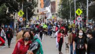 People wearing face masks walk down a street before the start of a mandatory total isolation decreed by the mayor's office, amidst an outbreak of the coronavirus disease (COVID-19), in Bogota, Colombia January 7, 2021. REUTERS/Luisa Gonzalez/File Photo