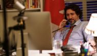 Canada's Prime Minister Justin Trudeau speaks on the phone with U.S. President Joe Biden, who made the first call to a foreign leader following his inauguration, in Ottawa, Ontario, Canada January 22, 2021. Picture taken January 22, 2021. Adam Scotti/Prim
