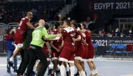 Qatar players celebrate after defeating Argentina in their final match of the Main Round of IHF Handball World Championship, in Cairo yesterday. TOP: Player of the Match, Qatar's Frankis Marzo celebrates with team-mates.  