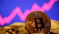 FILE PHOTO: A representation of virtual currency Bitcoin is seen in front of a stock graph in this illustration taken January 8, 2021. REUTERS/Dado Ruvic