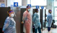 Healthcare workers prepare to test passengers as they arrive at Toronto's Pearson airport after mandatory coronavirus disease (COVID-19) testing took effect for international arrivals in Mississauga, Ontario, Canada February 1, 2021. REUTERS/Carlos Osorio