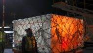 A security guard stands next to a batch of the AstraZeneca coronavirus disease (COVID-19) vaccine after its arrival at Benito Juarez's international airport in Mexico City, Mexico February 14, 2021. REUTERS/Henry Romero

