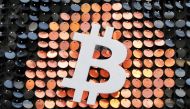 FILE PHOTO: FILE PHOTO: The logo of the Bitcoin digital currency is seen in a shop in Marseille, France, February 7, 2021. REUTERS/Eric Gaillard