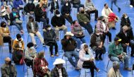 People wait seated to receive a dose of AstraZeneca coronavirus disease (COVID-19) vaccine at Municipal Gymnasium in Linares Mexico February 17, 2021. REUTERS/Daniel Becerril
