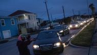 Residents line up in their vehicles to enter a warming center and shelter after record-breaking winter temperatures, as local media reports most residents are without electricity, in Galveston, Texas, U.S., February 17, 2021. Reuters/Adrees Latif 