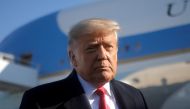 FILE PHOTO: U.S. President Donald Trump looks on as he speaks to the media before boarding Air Force One to depart Washington on travel to visit the U.S.-Mexico border Wall in Texas, at Joint Base Andrews in Maryland, U.S., January 12, 2021. REUTERS/Carlo