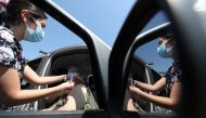 A healthcare worker administers a dose of Sinovac's CoronaVac coronavirus disease (COVID-19) vaccine at a drive-thru vaccination center in Santiago, Chile, February 26, 2021. REUTERS/Ivan Alvarado/File Photo