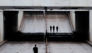 People run by an empty avenue during a lockdown decreed by Brasilia's Governor Ibaneis Rocha to slow the rate of the coronavirus disease (COVID-19) contagion in Brasilia, Brazil, February 28, 2021. REUTERS/Ueslei Marcelino
