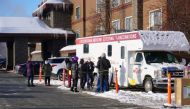 Support workers for the Iditarod Trail Sled Dog Race line up outside the Lakefront Anchorage Hotel, the site of the temporary Anchorage Iditarod headquarters, to be tested for coronavirus (COVID-19), in Anchorage, Alaska, U.S., March 4, 2021. The workers 