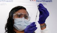 Jeanine Mucci, RN, prepares to administer the Johnson & Johnson's coronavirus disease (COVID-19) vaccine to Susan Maxwell-Trumble, 67, at Northwell Health's South Shore University Hospital in Bay Shore, New York, U.S., March 3, 2021. REUTERS/Shannon Stapl
