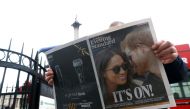 FILE PHOTO: A person is seen reading the London Evening Standard with the news that Prince Harry has announced his engagement to Meghan Markle, London, Britain, November 27, 2017. REUTERS/Darrin Zammit Lupi/File Photo
