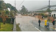 Floodwaters stream down a street in Hauula, Hawaii, U.S. March 9, 2021, in this still image obtained from a social media video. Courtesy of Adam Palmer/Social Media via REUTERS