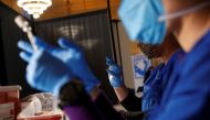 Pharmacists prepare the Pfizer COVID-19 vaccination to be administered to Metropolitan Transportation Authority (MTA) workers at Vanderbilt Hall at Grand Central Terminal in the Manhattan borough of New York, U.S. March 10, 2021. REUTERS/Shannon Stapleton