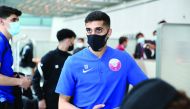 Qatar's Hassan Al Haydos and team-mates moments before boarding an aircraft ahead of their departure for Hungary yesterday. 
