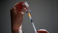 FILE PHOTO: A pharmacist prepares a dose of the AstraZeneca COVID-19 vaccine in a pharmacy in Paris as part of the coronavirus disease (COVID-19) vaccination campaign in France, March 19, 2021. REUTERS/Benoit Tessier