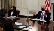 U.S. President Joe Biden is flanked by Vice President Kamala Harris as he speaks with HHS Secretary Xavier Becerra during a meeting with immigration advisers in the State Dining Room at the White House in Washington, U.S., March 24, 2021. REUTERS/Jonathan