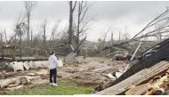 A man looks at damage and debris in the aftermath of a tornado in Centreville, Alabama, U.S. March 25, 2021, in this still image obtained from a social media video. Courtesy of Brayden Siau/Social Media via REUTERS