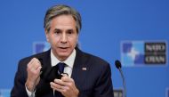 FILE PHOTO: U.S. Secretary of State Antony Blinken removes his mask as gives a press briefing at the end of a NATO Foreign Ministers' meeting at the Alliance's headquarters in Brussels, Belgium, March 24, 2021. Olivier Hoslet/Pool via Reuters