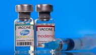 FILE PHOTO: Vials with Pfizer-BioNTech and Moderna coronavirus disease (COVID-19) vaccine labels are seen in this illustration picture taken March 19, 2021. REUTERS/Dado Ruvic/Illustration/File Photo
