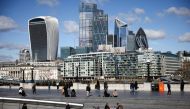 The City of London financial district can be seen as people walk along the south side of the River Thames, amid the coronavirus disease (COVID-19) outbreak in London, Britain, March 19, 2021. REUTERS/Henry Nicholls//File Photo