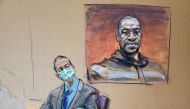 FILE PHOTO: Former Minneapolis police officer Derek Chauvin sits in front of a picture of George Floyd displayed during Chauvin's trial for second-degree murder, third-degree murder and second-degree manslaughter in the death of Floyd in Minneapolis, Minn