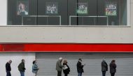People wait in line to receive a dose of AstraZeneca's COVID-19 vaccine outside a vaccination centre, at the Wanda Metropolitano stadium, in Madrid, Spain, March 31, 2021. REUTERS/Susana Vera