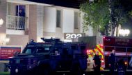 City of Orange police officers stand in front of a building after a shooting in Orange, California, U.S. March 31, 2021. Reuters/Alex Gallardo