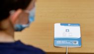 An antigen rapid test kit lies in front of a child at a re-opened elementary school, as restrictions ease following the coronavirus disease (COVID-19) outbreak in Prague, Czech Republic, April 12, 2021. REUTERS/David W Cerny
