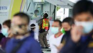 A healthcare worker takes a nasal swab sample from a police officer for a coronavirus disease (COVID-19) test, as the country deals with a fresh wave of infections after tackling earlier outbreaks, in Bangkok, Thailand April 16, 2021. REUTERS/Athit Perawo