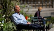 A person sits in Bryant Park after the Centers for Disease Control and Prevention (CDC) announced new guidelines regarding outdoor mask wearing and vaccination during the outbreak of the coronavirus disease (COVID-19) in Manhattan, New York City, New York