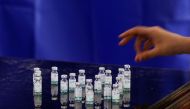 A health worker counts used vials of Sinopharm's coronavirus disease (COVID-19) vaccine, at a vaccination centre in Karachi, Pakistan April 28, 2021. REUTERS/Akhtar Soomro
