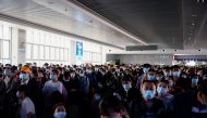 People wearing masks are seen arriving at Shanghai railway station in Shanghai, ahead of the 5-day Labor Day holidays, in China April 30, 2021. REUTERS/Aly Song