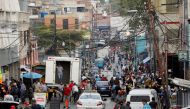 People walk on a busy commercial street amid a spike in infections of the coronavirus disease (COVID-19) that has led the government to extend lockdown measures, in Caracas, Venezuela April 6, 2021. REUTERS/Leonardo Fernandez Viloria/File Photo/File Photo