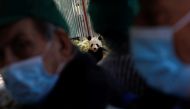 A panda bear eats as residents from Casaverde nursing homes visit the zoo during their first group outing since the start of the coronavirus disease (COVID-19) pandemic, in Madrid, Spain, May 5, 2021. REUTERS/Susana Vera
