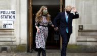 Britain's Prime Minister Boris Johnson and partner Carrie Symonds leave Westminster polling station after voting, in London, Britain May 6, 2021. REUTERS/Henry Nicholls