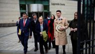 Solicitor for the McCann family Niall Murphy (red tie) with Joe McCann's family, (left to right) son Fergal, widow Anne, daughter Nuala, nephew Fergal, and daughter Aine (right) depart Laganside Court, after the trial into the 1972 killing of official IRA