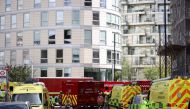 Vehicles of incident response unit are seen outside a damaged residential building in East London, Britain, May 7, 2021. REUTERS/Henry Nicholls