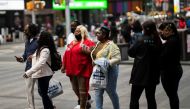 People make their way at Times Square, amid the coronavirus disease (COVID-19) pandemic, in Manhattan, New York City, U.S., May 7, 2021. REUTERS/Eduardo Munoz