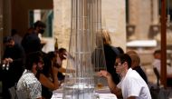 People sit at an outdoor patio as restaurants and markets reopened for business after coronavirus disease (COVID-19) vaccinations reached 60% of the adult population, in Valletta, Malta May 10, 2021. REUTERS/Darrin Zammit Lupi