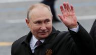 Russian President Vladimir Putin waves while walking along Red Square after a military parade on Victory Day, which marks the 76th anniversary of the victory over Nazi Germany in World War Two, in central Moscow, Russia May 9, 2021. REUTERS/Evgenia Novozh