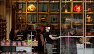 An employee opens doors of a clothing store on a first day of the re-opening of retail stores, amid the coronavirus disease (COVID-19) pandemic in Prague, Czech Republic, May 10, 2021. REUTERS/David W Cerny
