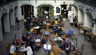FILE PHOTO: People sit at outside restaurant area, as the coronavirus disease (COVID-19) restrictions ease, at Covent Garden in London, Britain April 12, 2021. REUTERS/Henry Nicholls/File Photo
