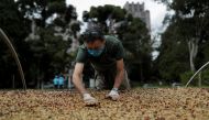 A man spreads coffee grains for drying at the Biological Institute plantation in Sao Paulo, Brazil May 8, 2021. Picture taken May 8, 2021. REUTERS/Amanda Perobelli