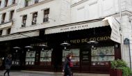 FILE PHOTO: People, wearing protective face masks, walk past a closed restaurant in Paris amid the coronavirus disease (COVID-19) outbreak in France, May 6, 2021. REUTERS/Sarah Meyssonnier