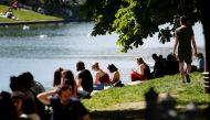 People relax at Landswehrkanal in Kreuzberg District on a sunny, warm day in Berlin, Germany, May 10, 2021. REUTERS/Michele Tantussi
