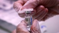 A healthcare clinician prepares a dose of the Johnson & Johnson vaccine for the coronavirus disease (COVID-19) for a commuter during the opening of MTA's public vaccination program at the 179th Street subway station in the Queens borough of New York City,
