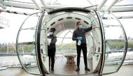 Hosts clean a pod of London Eye in preparation to reopen as coronavirus disease (COVID-19) restrictions continue to ease, in London, Britain, May 14, 2021. REUTERS/Peter Cziborra