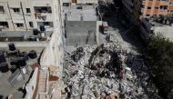 A general view as rescue workers search for victims amid rubble at the site of Israeli air strikes, in Gaza City May 16, 2021. REUTERS/Mohammed Salem